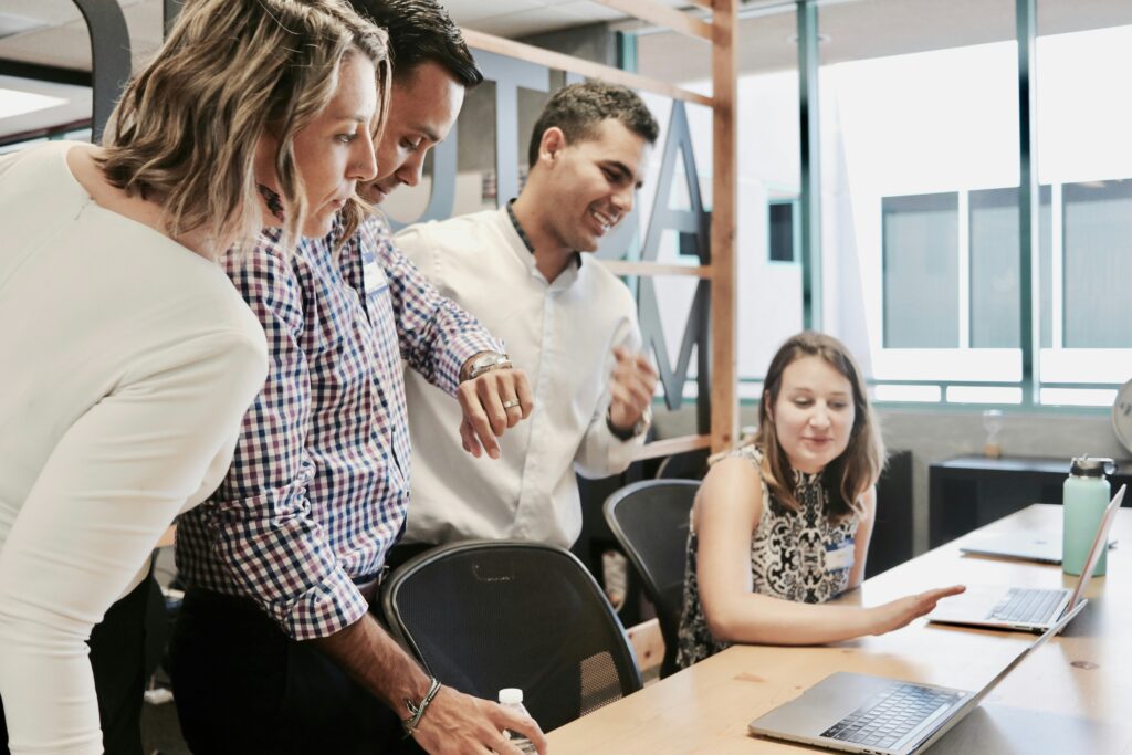 A group of professionals looking at a computer together